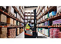 A warehouse packed with goods with an African worker driving a palette lift through high shelves - photographic style.jpg - Building a billion rand business in the heart of Soweto image
